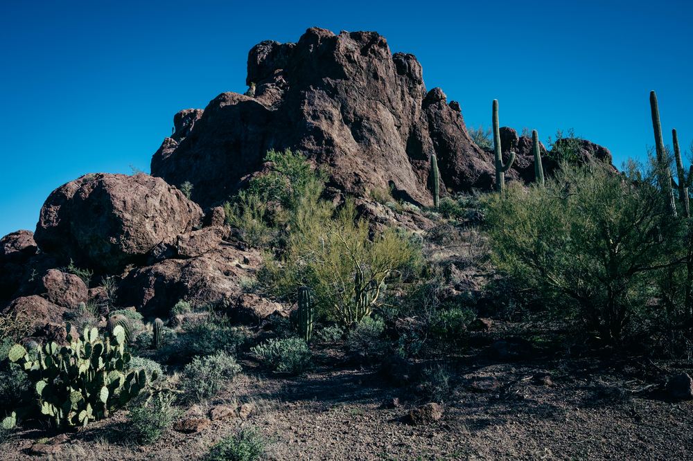 A rocky desert peak under a clear sky